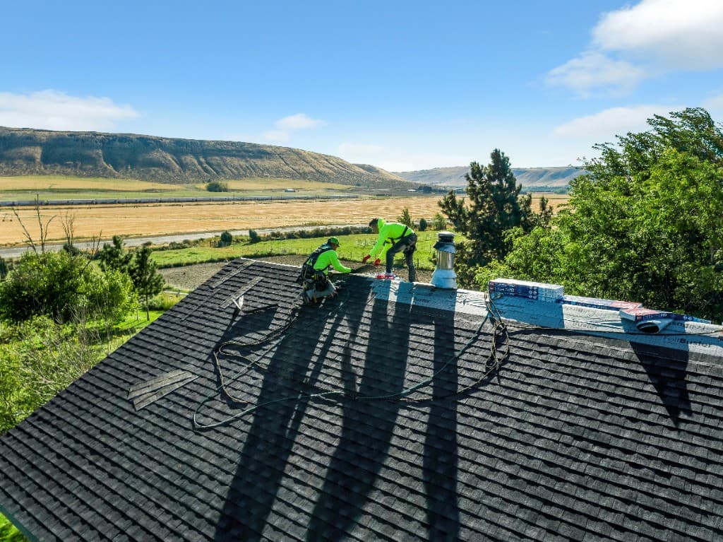 Eminent Roofing crew installing asphalt shingles on an Eastern Washington roof