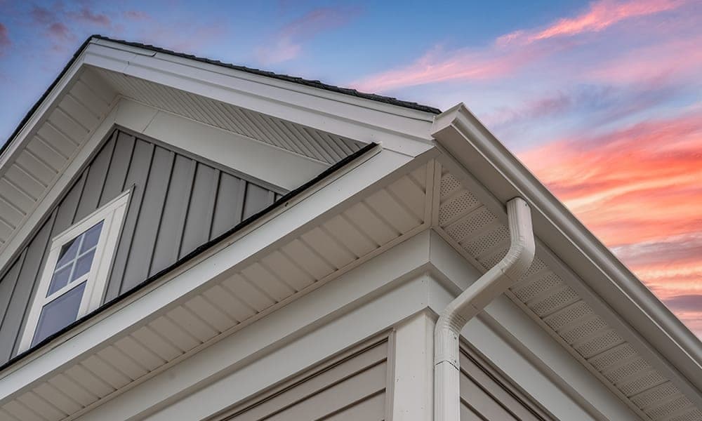 Home roofline with gutters and downspouts