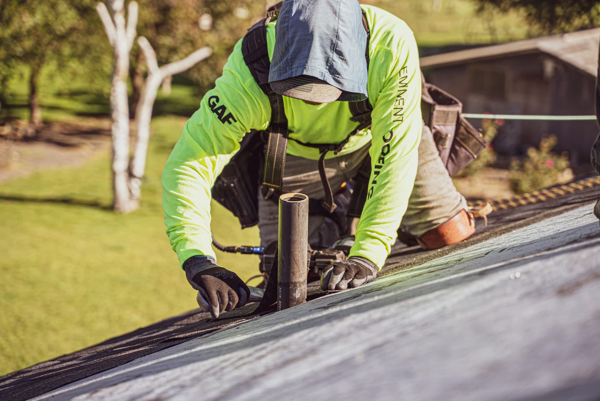 An Eminent Roofing crew member securing a ridge vent on a GAF asphalt shingle roof